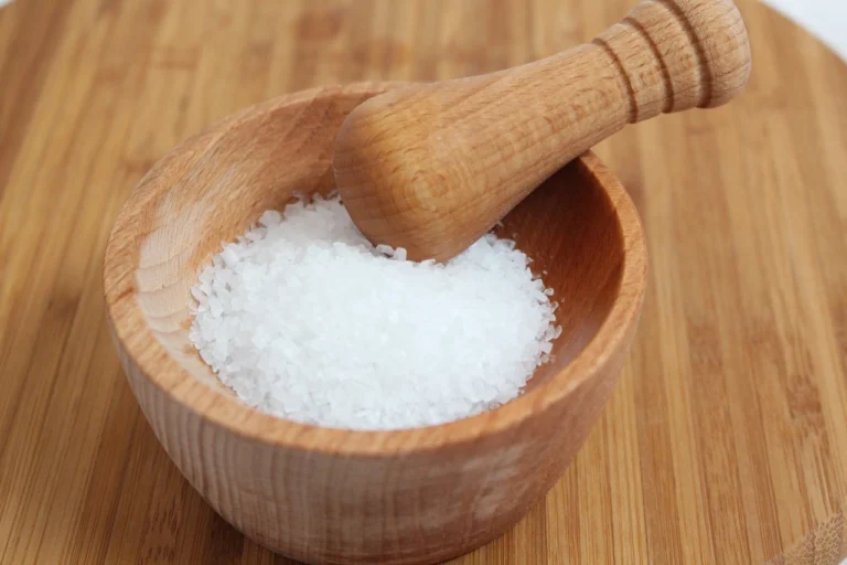 white salt in a wooden bowl of brown color